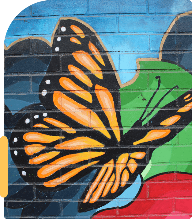 Colorful mural of an orange and black butterfly on a blue and green background.